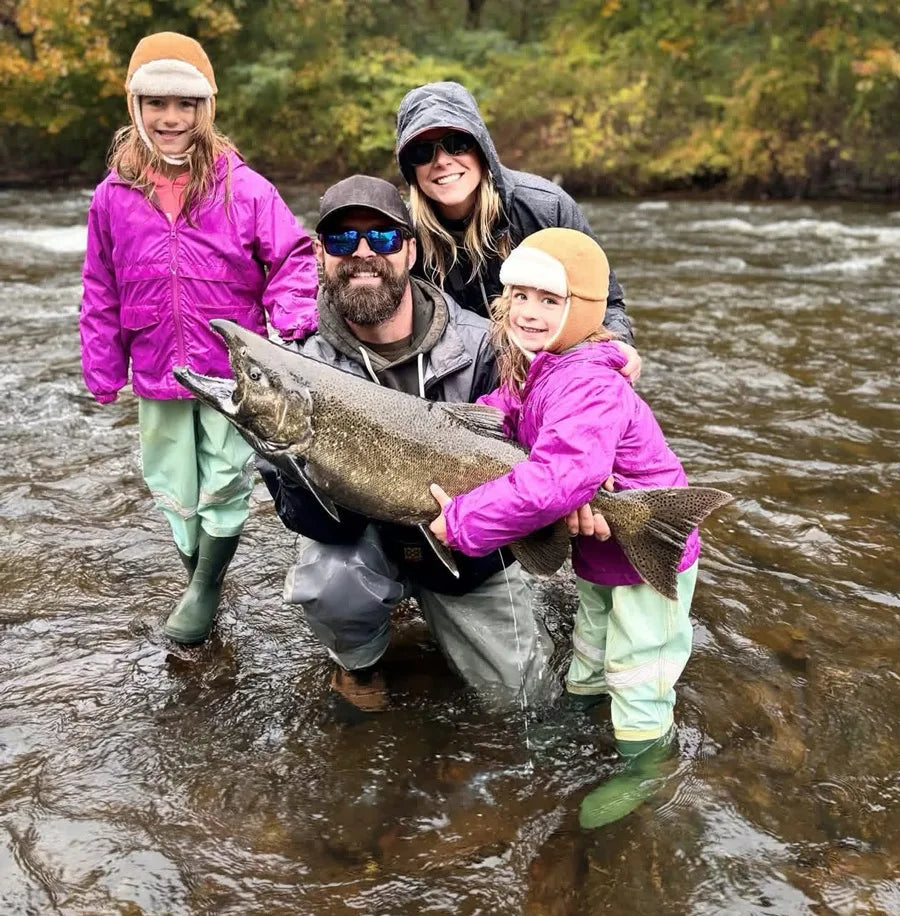 Angler with a king salmon beside the low-flow Salmon River in September