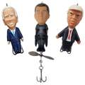 Three bobblehead figures of political figures with a fishing lure on a transparent background