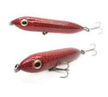 Two red fishing lures with a textured pattern on a white background