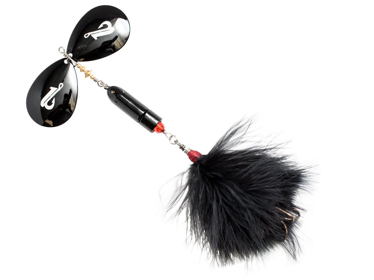 Black and red fishing lure with a fluffy tail on a white background