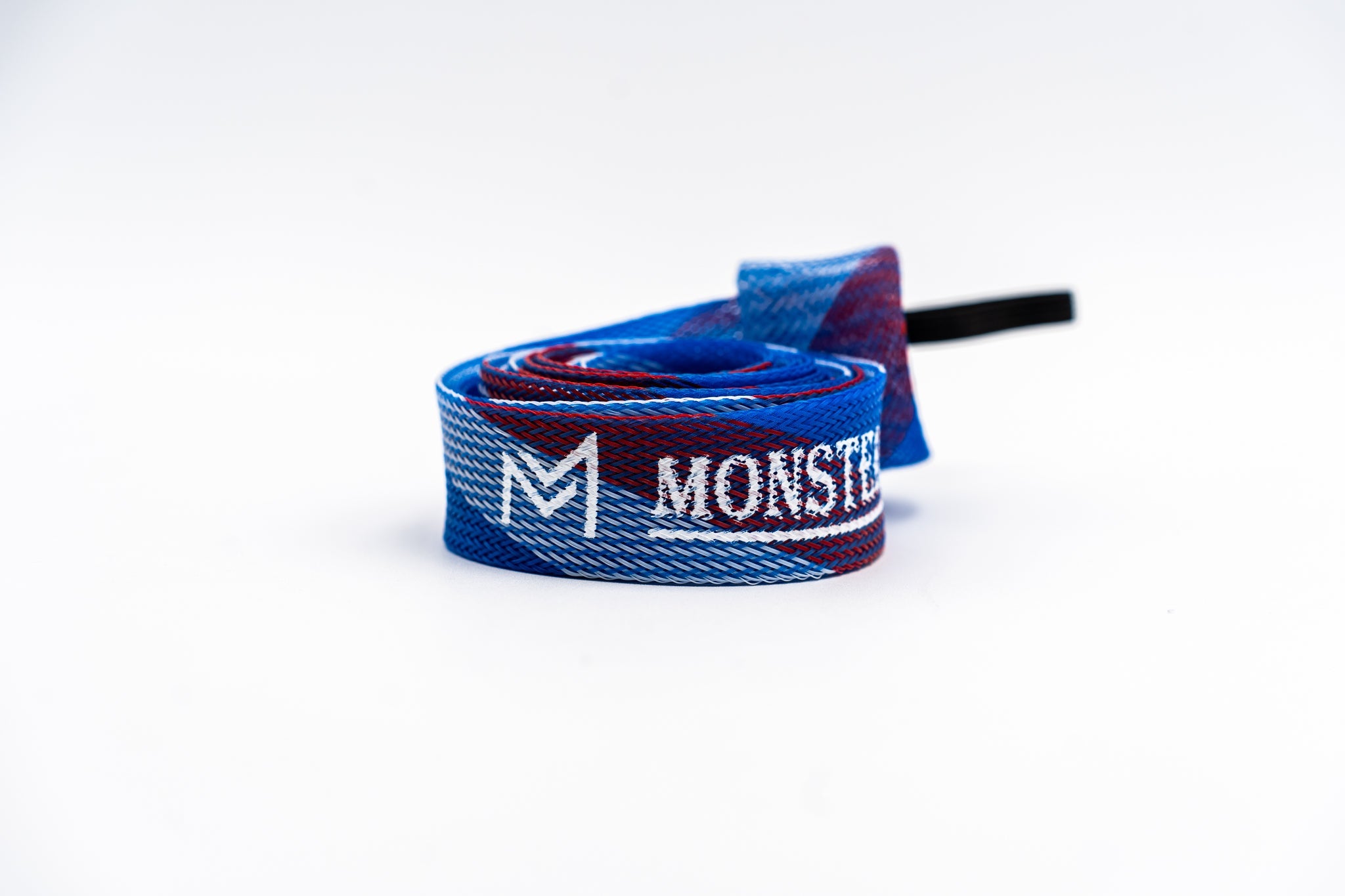 Blue and red shoelace with 'Monster' branding on a white background