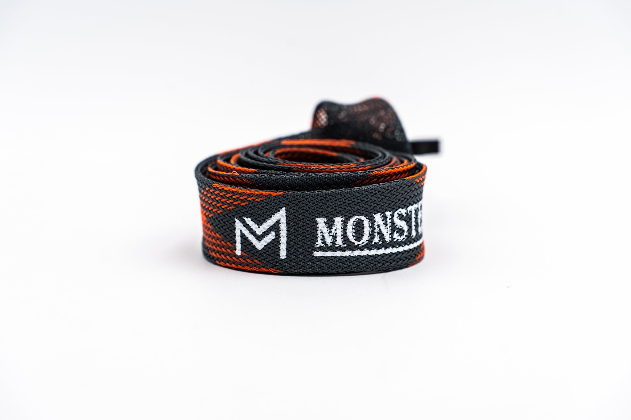 Black and orange strap with 'MONSTER' branding on a white background