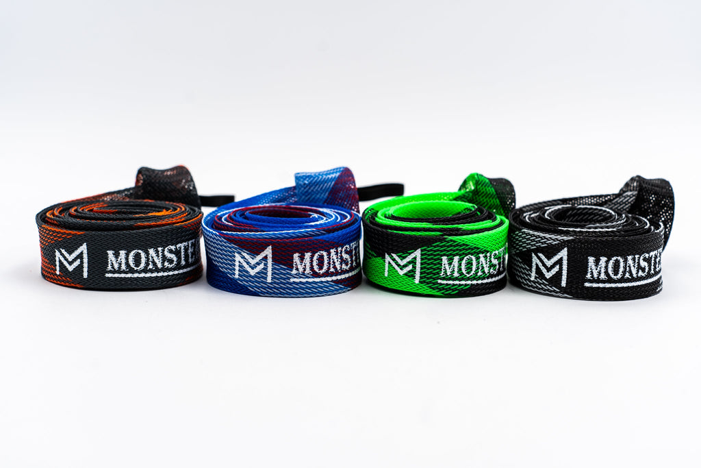 Four Monster brand straps in different colors on a white background