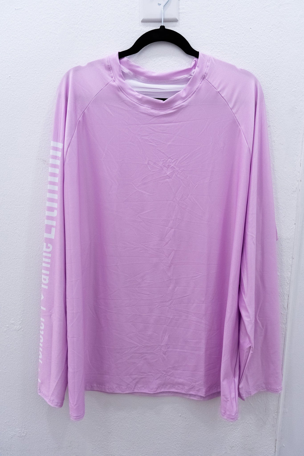 Purple long-sleeve shirt on a hanger against a white background