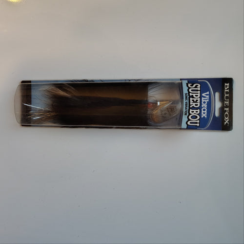 Packaged fishing lure on a white surface