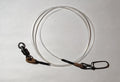 Fishing tackle including a spool of line and a package on a white surface