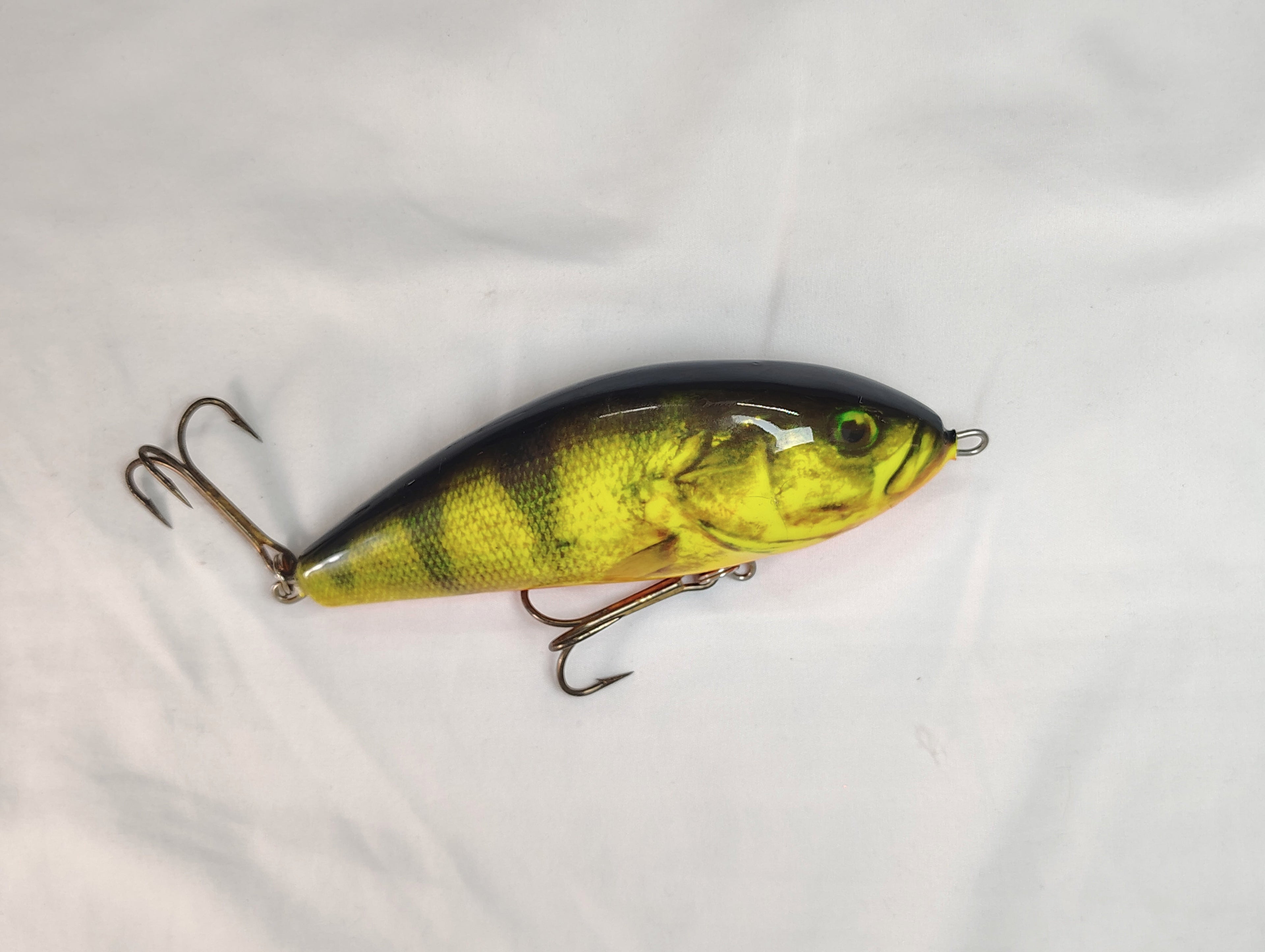 Fishing lure with a yellow and black pattern on a white background