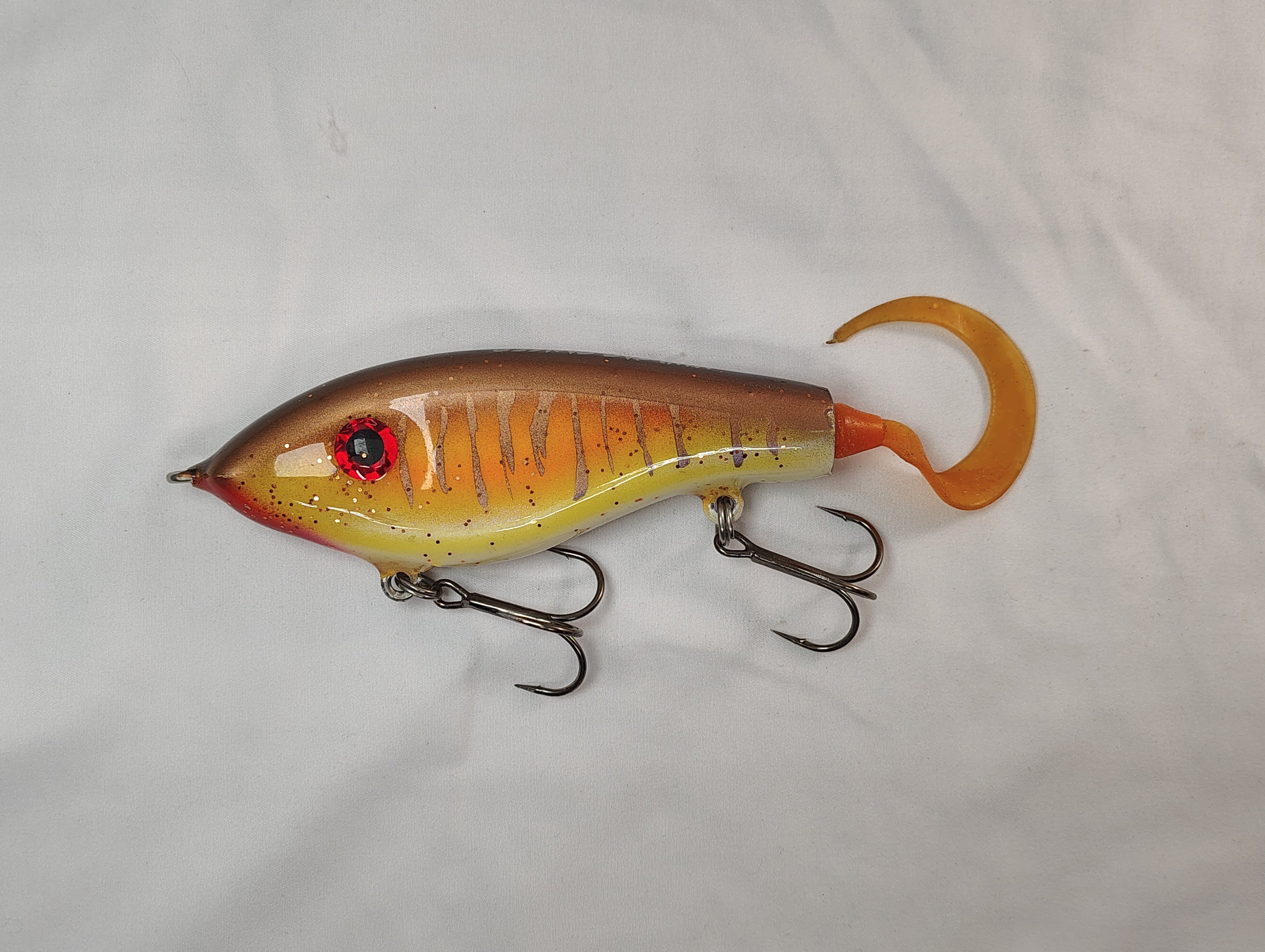 Fishing lure with a gradient color pattern on a white background