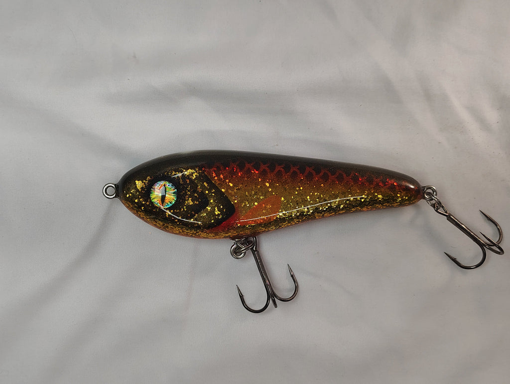 Fishing lure with metallic finish on a white background