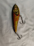 Fishing lure with a glittery finish on a white background