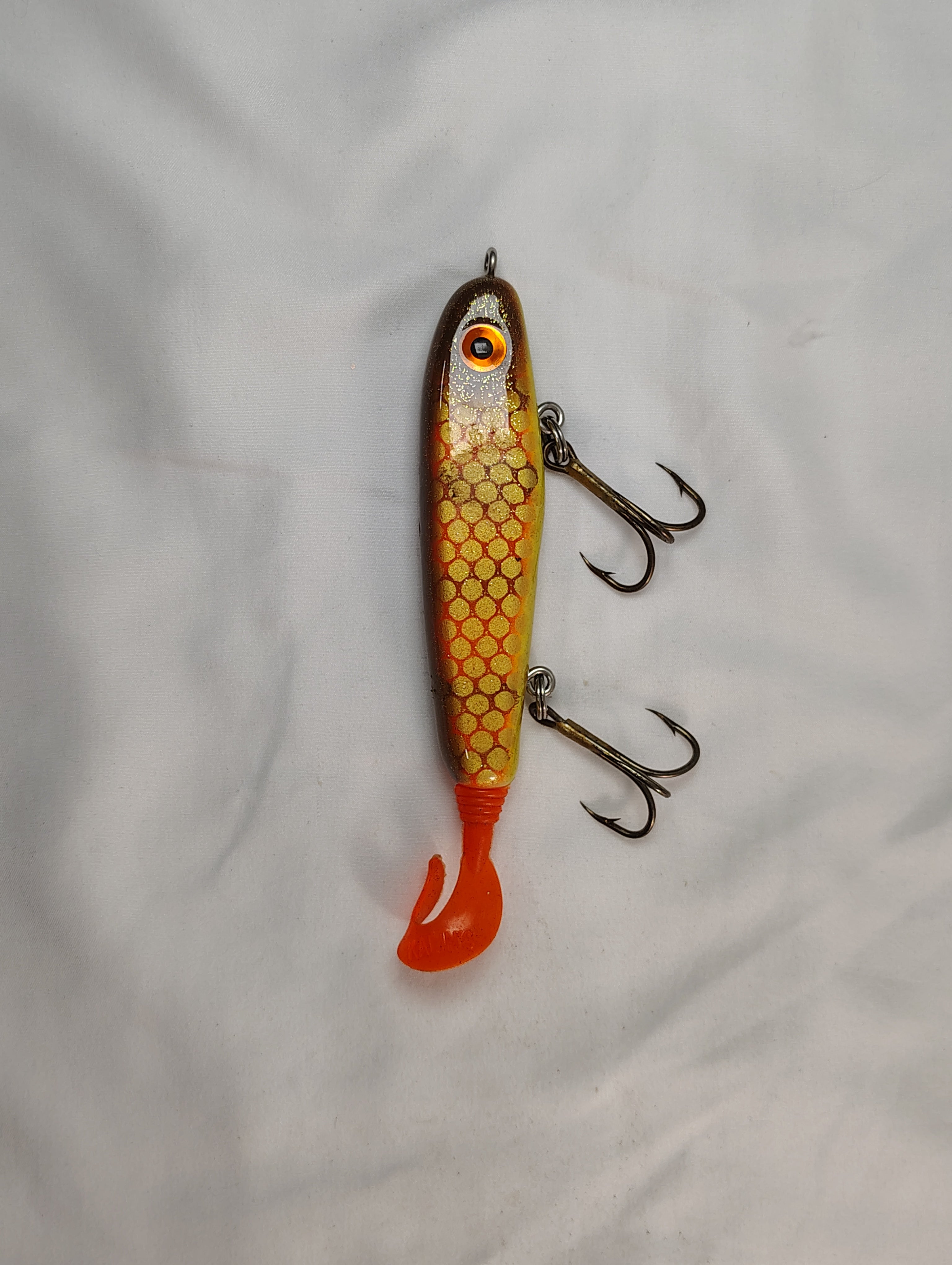 Fishing lure with a honeycomb pattern on a white background