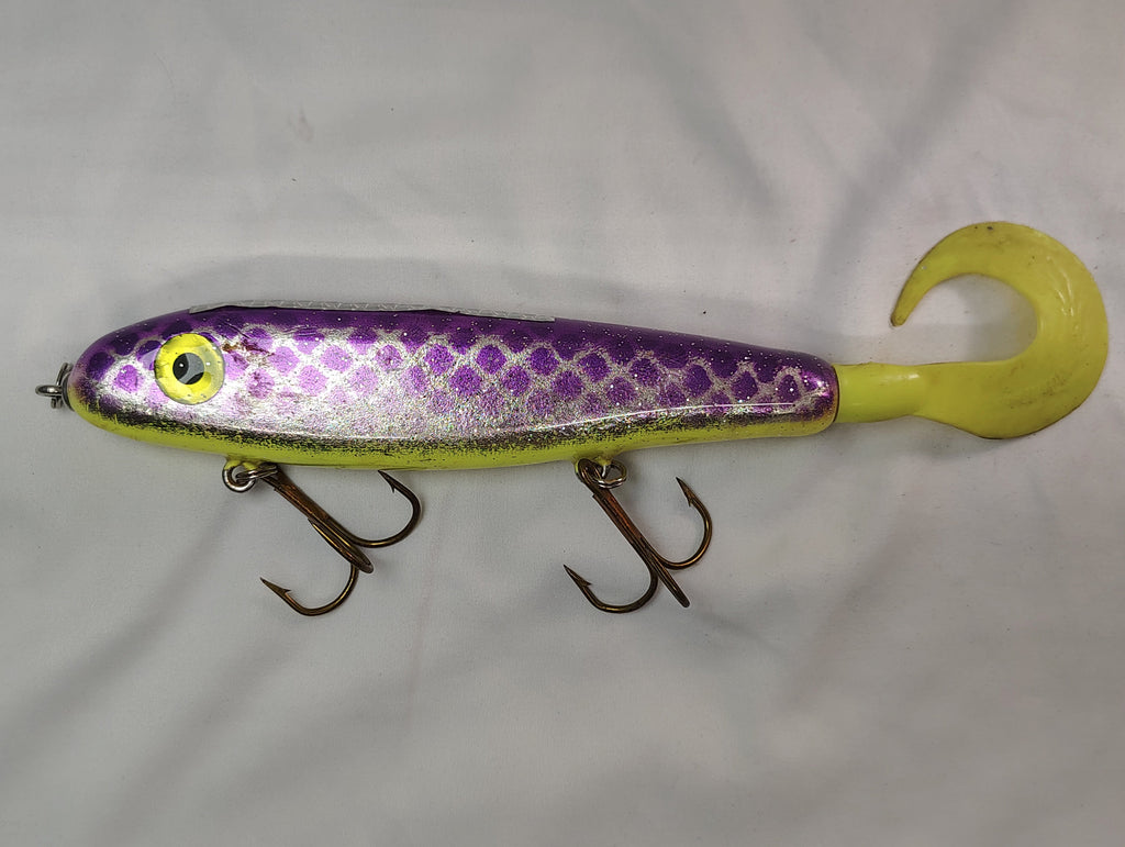 Fishing lure with purple and yellow design on a white background