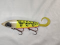 Fishing lure with yellow and black pattern on a white background