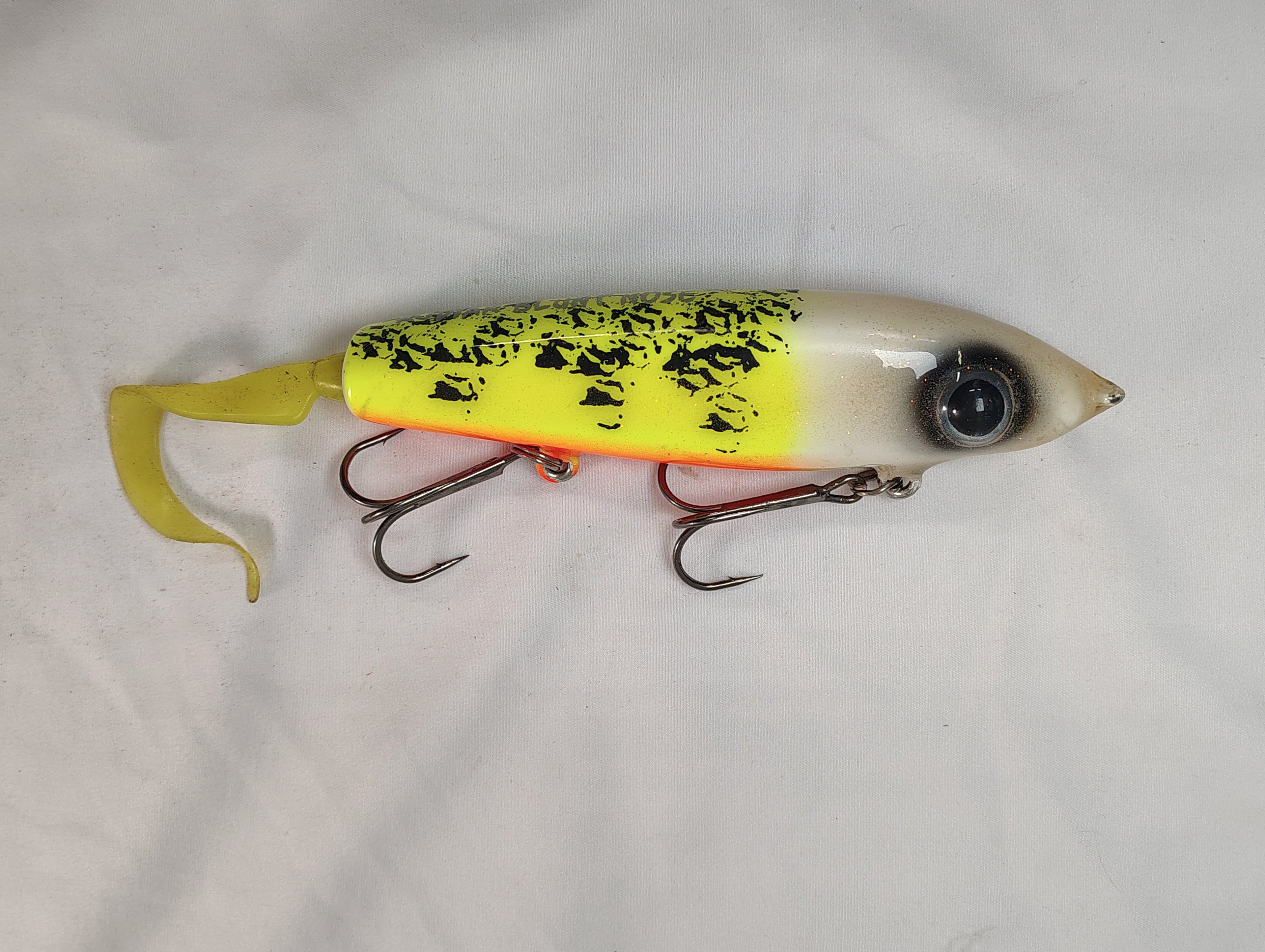 Yellow and black fishing lure on a white background