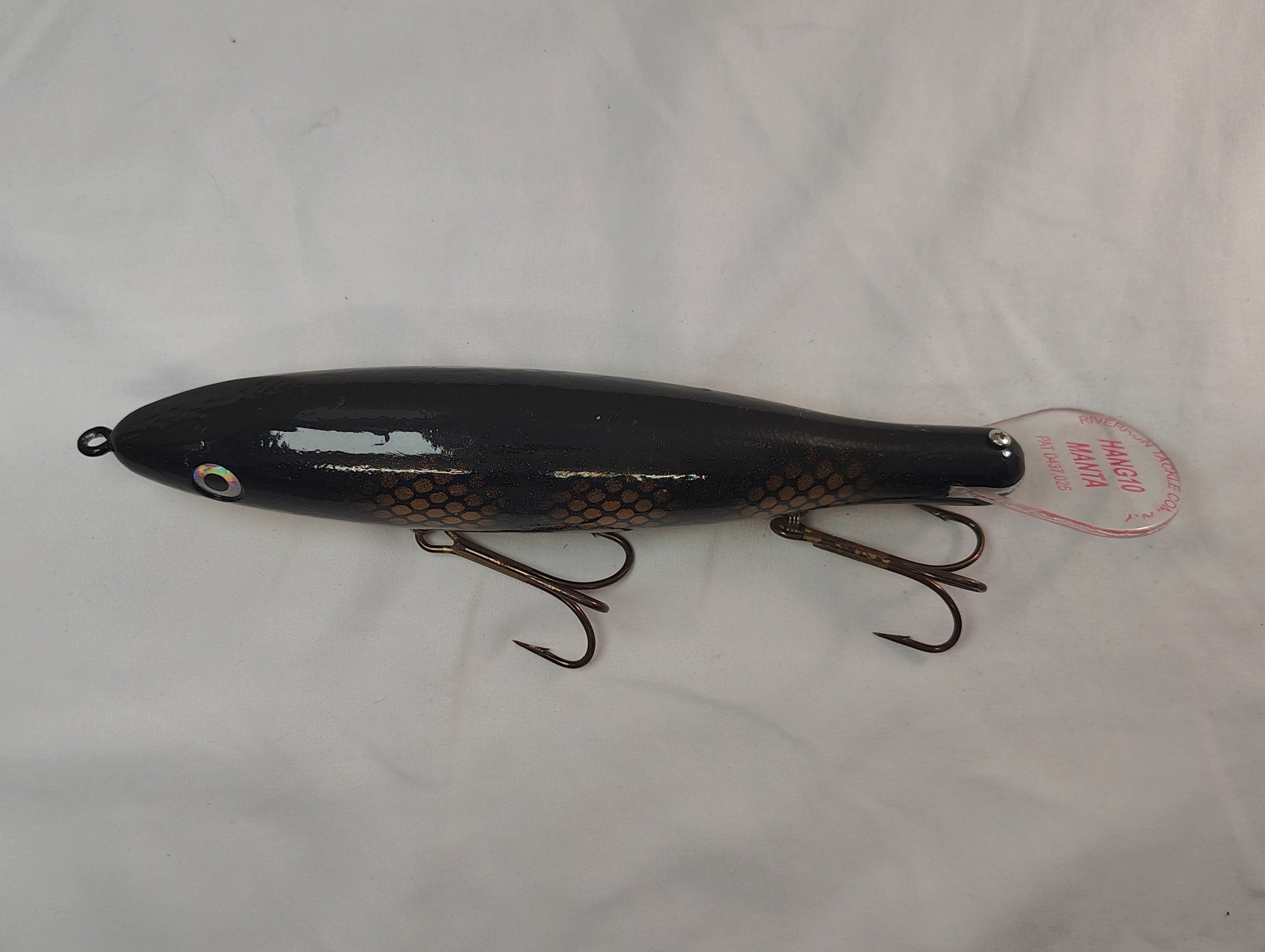 Black fishing lure with a tag on a white background