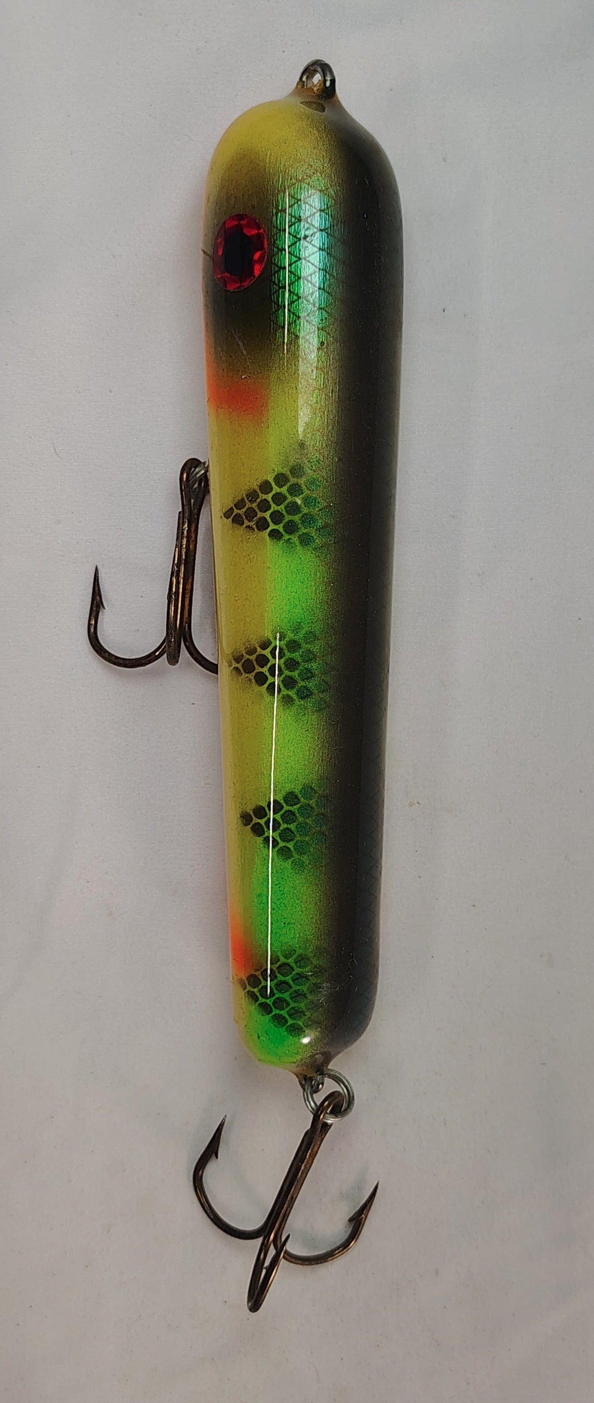 Fishing lure with a striped pattern on a white background