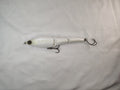 White fishing lure with a hook on a white background