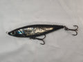 Metallic fishing lure on a white fabric background