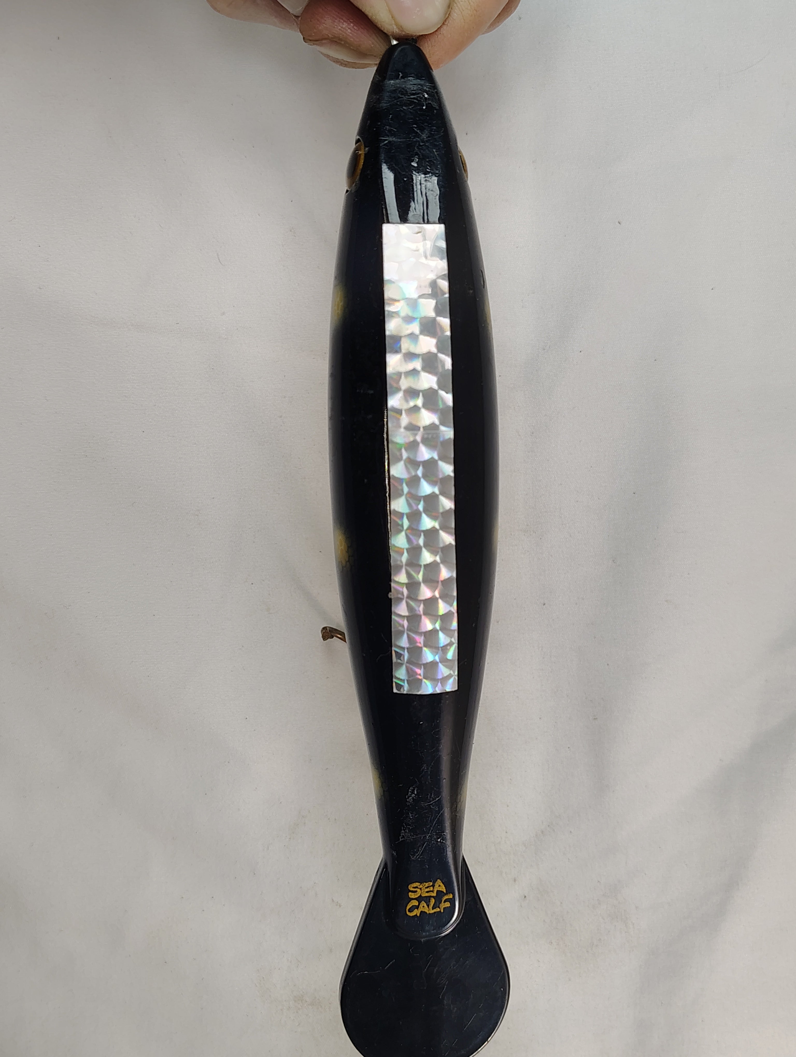 Black handle with a silver inlay on a white background