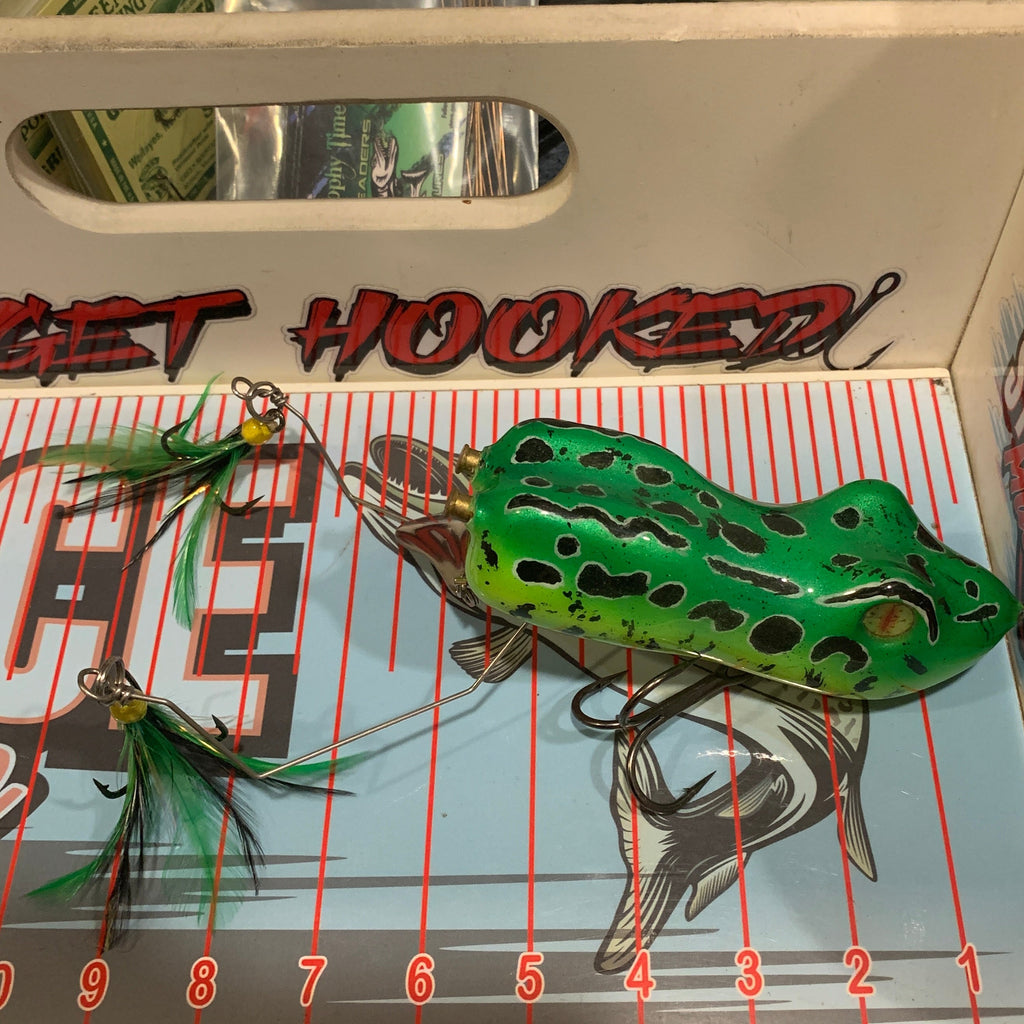 Green frog-shaped fishing lure on a measuring scale with 'Get Hooked' branding.