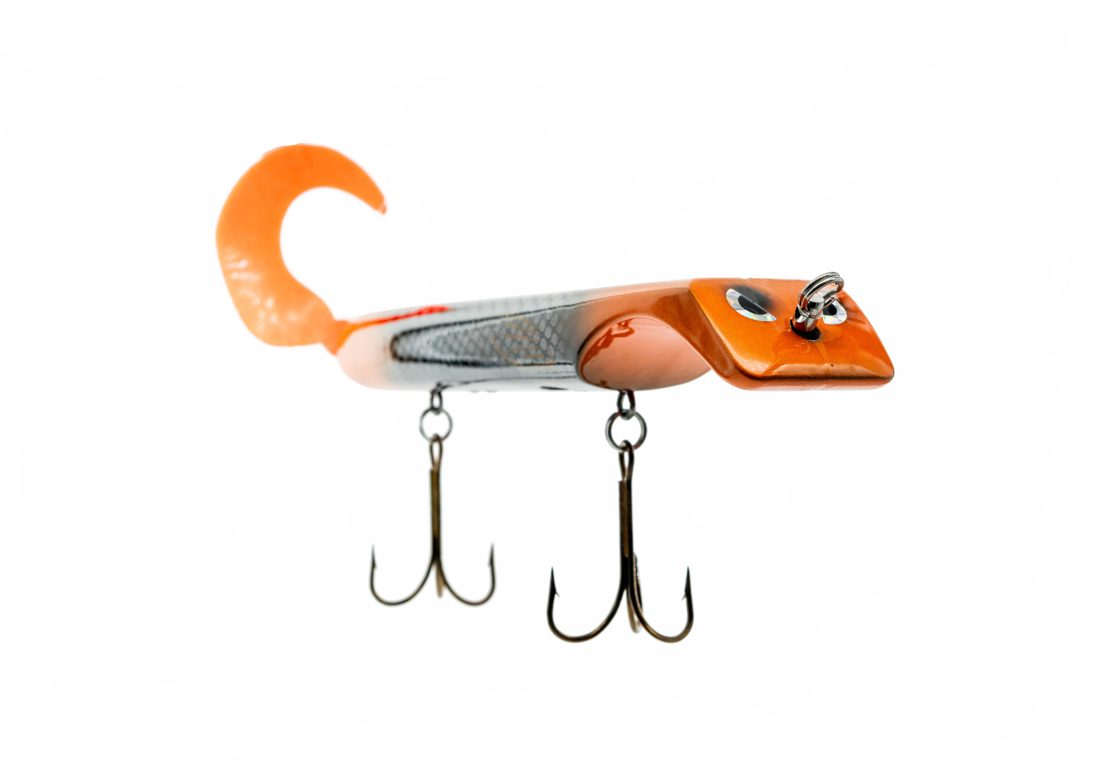 Orange and silver fishing lure with treble hooks on a white background