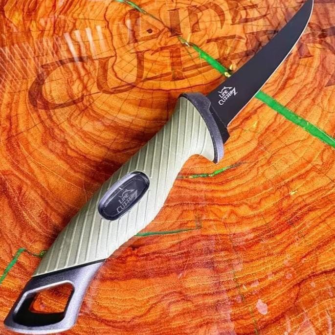 Knife with a green and black handle on a wooden surface